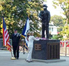 Congresswoman Shelly Moore Capito places a flower at the foot of the Fallen Fire Fighter’s Memorial at the WV State Capitol Complex.